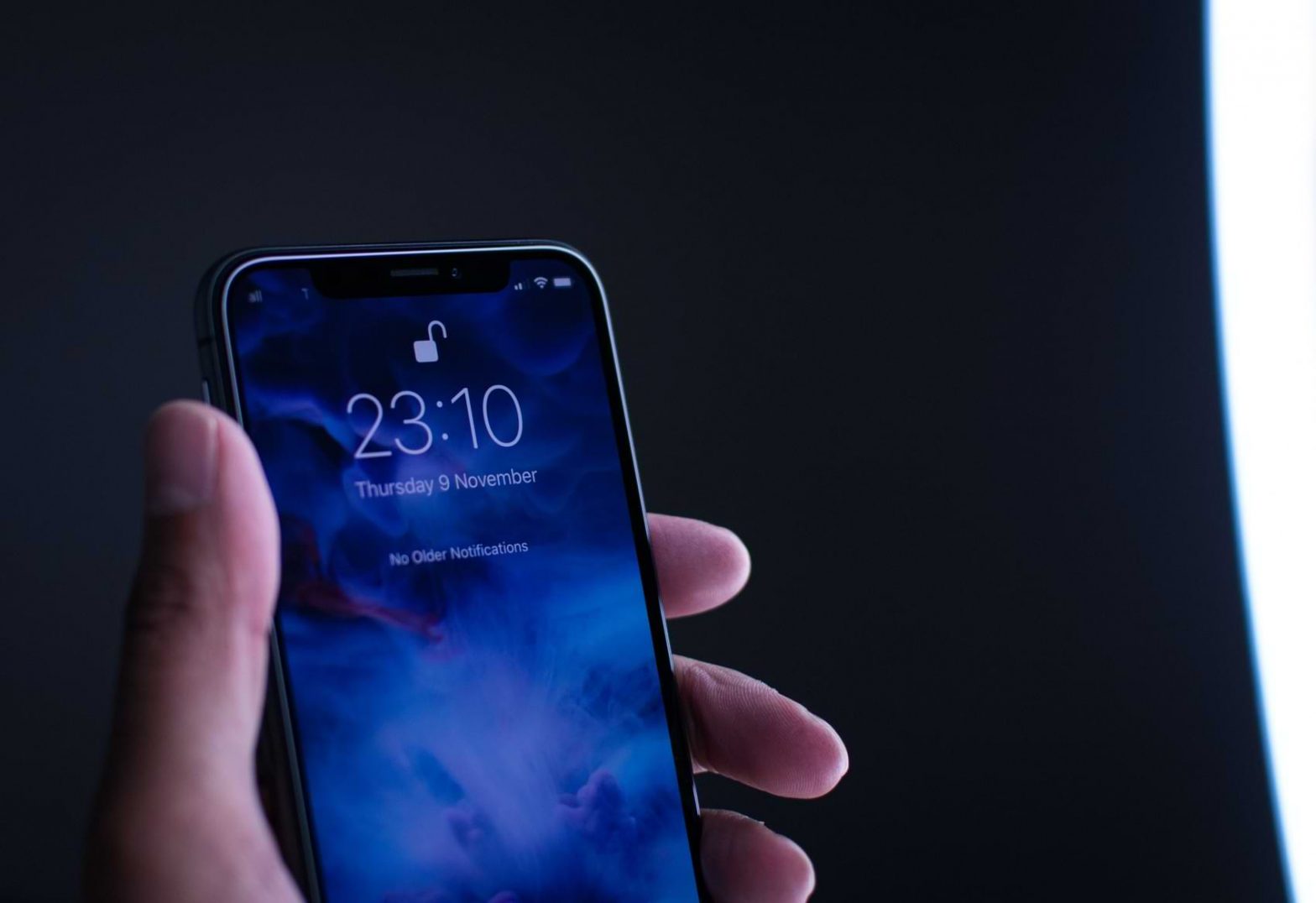 A locked phone is shown unlocking in its users hand