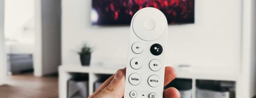 A remote controlling a Smart TV, which could be on either side of the Fibe TV vs cable debate